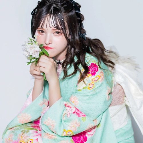 ペールブルーの振袖に華やかな花々が描かれた、爽やかでフェミニンな成人式コーディネート